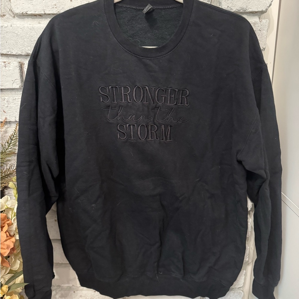 “Stronger than the storm” Black Crewneck Sweater